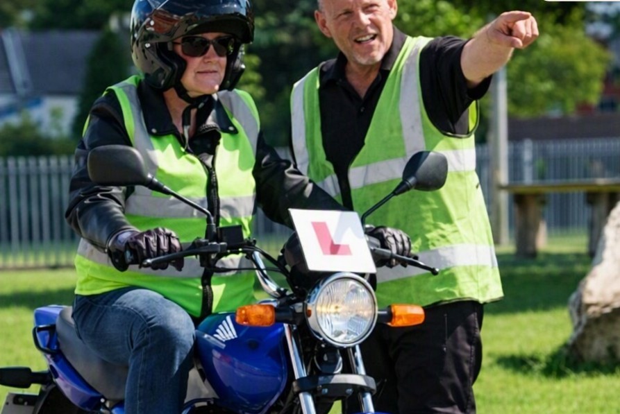 Driving instructor with a learner in a lesson vehicle
